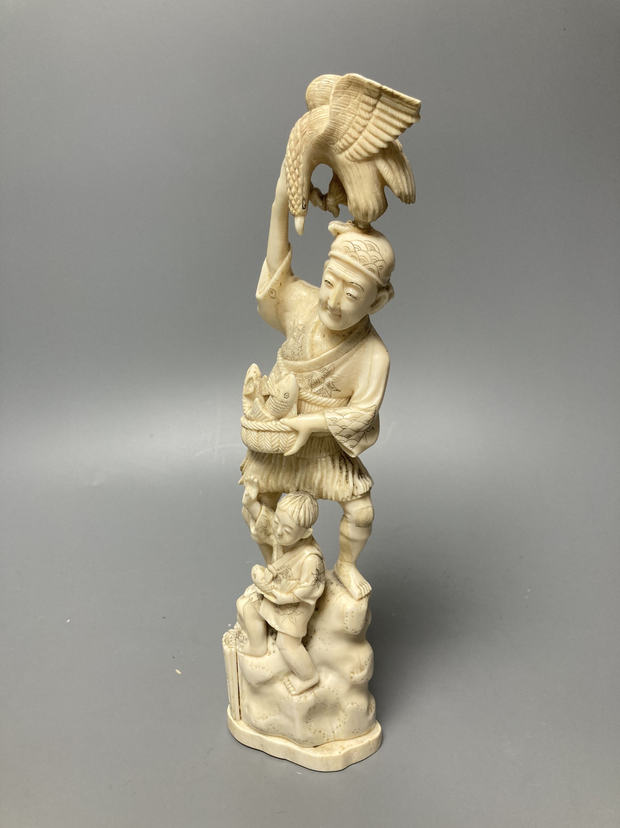 A Japanese walrus ivory okimono of a fisherman and boy, height 30cm